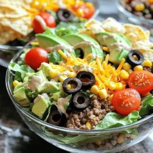 To make a tasty taco salad, gather these main ingredients: - 1 pound ground turkey or beef - 1 teaspoon taco seasoning - 1 head of romaine lettuce, chopped - 1 cup cherry tomatoes, halved - 1 cup corn kernels (canned or frozen and thawed) - 1 cup black beans, rinsed and drained - 1 avocado, diced - 1 cup shredded cheese (cheddar or Mexican blend) - 1/2 cup sliced black olives - Tortilla chips, for serving These ingredients blend well together. The meat brings protein, while the veggies add freshness. You can swap the ground meat for a plant-based option if you prefer. For the creamy chipotle ranch dressing, you need: - 1/2 cup ranch dressing - 1 tablespoon chipotle in adobo sauce, minced - 1 tablespoon lime juice - Salt and pepper, to taste This dressing gives your salad a smoky kick. The ranch balances the heat from the chipotle. You can adjust the lime juice to suit your taste. You can customize your taco salad with these optional toppings: - Fresh cilantro, chopped - Jalapeños, sliced - Sour cream or Greek yogurt - Additional cheese, like queso fresco - Sliced green onions Feel free to mix and match toppings. They add fun flavors and textures. Use what you have on hand for a personal touch. For the full recipe, check out Taco Salad Delight. First, heat a skillet over medium heat. Add 1 pound of ground turkey or beef to the pan. Cook the meat until it turns brown and is fully cooked. This takes about 6-8 minutes. Once cooked, sprinkle in 1 teaspoon of taco seasoning. Stir well to coat the meat. Add a splash of water to help mix the spices. Let it simmer for 3-4 minutes. This makes the meat juicy and full of flavor. Remove the skillet from heat and set the meat aside. Grab a large mixing bowl. Start with 1 head of chopped romaine lettuce. This gives your salad a fresh crunch. Next, add 1 cup of halved cherry tomatoes for sweetness. Toss in 1 cup of corn kernels, either canned or frozen and thawed. Add 1 cup of rinsed and drained black beans for protein. Don't forget 1 diced avocado for creaminess. Then sprinkle in 1 cup of shredded cheese, either cheddar or a Mexican blend. Finally, add 1/2 cup of sliced black olives for a salty bite. In a small bowl, combine 1/2 cup of ranch dressing with 1 tablespoon of minced chipotle in adobo sauce. This gives the dressing a smoky kick. Add 1 tablespoon of fresh lime juice for tanginess. Mix well until smooth. Taste and season with salt and pepper. Adjust to your liking. This dressing adds great flavor to the salad. Now, take the cooked meat and add it to the salad base. Toss everything gently to mix. This helps distribute the flavors. Drizzle the chipotle ranch dressing over the salad. Toss again to coat everything evenly. For serving, place the taco salad in individual bowls or on a large platter. Top with crushed tortilla chips for extra crunch. The chips add a fun texture and make the dish even more enjoyable. Enjoy your Taco Salad with Chipotle Ranch Dressing Delight! For the full recipe, refer to the recipe section above. To get the best flavor, season your meat well. Use taco seasoning to bring out the spices. You can also add garlic and onion for extra depth. Mix in a splash of lime juice for brightness. That little bit makes a huge difference! To save time, cook the meat ahead of time. You can store it in the fridge for up to three days. Chop your veggies ahead of time too; this makes it easy to grab and go. You can even make the chipotle ranch dressing in advance. Just keep it in an airtight container. Keep your salad crisp by adding ingredients just before serving. Store the lettuce and other veggies separately until you're ready to eat. This way, they stay fresh and crunchy. Crush the tortilla chips right before serving for the best texture. Enjoy that perfect crunch in every bite! {{image_2}} You can easily make this taco salad vegetarian or vegan. Use lentils or tempeh instead of ground turkey or beef. Both add great texture and flavor. For a vegan dressing, swap ranch for a plant-based version. Add mashed avocado or cashew cream for creaminess. This keeps your salad rich and satisfying without meat. Feel free to mix and match ingredients in your taco salad. Instead of romaine, try spinach or mixed greens. You can use any beans you like, such as pinto or kidney beans. If you don’t have black olives, slice up green olives or skip them altogether. You can also add other veggies, like bell peppers or cucumbers, for extra crunch. While the chipotle ranch dressing is fantastic, try other dressings too. A zesty lime vinaigrette can brighten the salad. For a spicy kick, use a sriracha or lime yogurt dressing. You can even make a simple olive oil and vinegar dressing. Each dressing gives your salad a new twist and keeps things exciting. Try the full recipe for more flavor ideas and fun! You can store taco salad in the fridge. Keep it in an airtight container. It will stay fresh for up to three days. If you have leftovers, do not add the dressing until you are ready to eat. This keeps the salad crisp and tasty. Freezing taco salad is not a good idea. The lettuce and tomatoes will become soggy. However, you can freeze the meat mixture. Store it in a freezer-safe bag. It will stay good for about three months. Thaw it in the fridge before using it again. When you have leftovers, keep them simple. Use the salad base without the dressing. Store each part separately. This helps maintain the flavors and textures. For a quick meal, simply combine your leftovers with fresh ingredients. You can check out the Full Recipe for ideas on how to use them. To make Taco Salad with Chipotle Ranch Dressing, first cook 1 pound of ground turkey or beef in a skillet. Use medium heat until it turns brown. Add 1 teaspoon of taco seasoning and a splash of water. Let it simmer for about 3-4 minutes. In a large bowl, combine chopped romaine lettuce, halved cherry tomatoes, corn, black beans, diced avocado, shredded cheese, and sliced olives. For the dressing, mix 1/2 cup of ranch dressing, 1 tablespoon of minced chipotle in adobo, and 1 tablespoon of lime juice in a small bowl. Toss everything together and serve with tortilla chips. You can use ground chicken or pork as a substitute. If you want a meatless option, try black beans, lentils, or crumbled tofu. These options add protein and keep the dish hearty. You can also use tempeh or jackfruit for a unique twist. Yes, you can prepare the salad in advance. Just keep the salad ingredients and dressing separate until you are ready to serve. This helps keep the lettuce crisp and fresh. You can store the salad in the fridge for up to 24 hours. Taco Salad is a great meal prep option. You can mix and match ingredients to fit your taste and diet. It stores well and keeps its flavor. When stored properly, it lasts for several days. Just remember to add the dressing right before eating. The Chipotle Ranch Dressing lasts about 3-5 days in the fridge. Store it in an airtight container to keep it fresh. If you notice any changes in color or smell, it's best to discard it. You can also make a larger batch and enjoy it on other salads or wraps. In this blog post, I covered the basics of taco salad, from ingredients to storage tips. You learned about the key components, tasty variations, and how to prepare and enjoy your meal. Remember, taco salad is fun to customize, making it great for anyone. Try different toppings or dressings to find your favorite mix. Use these steps to make a delicious meal anytime. Enjoy your cooking and savor your taco salad experience!
