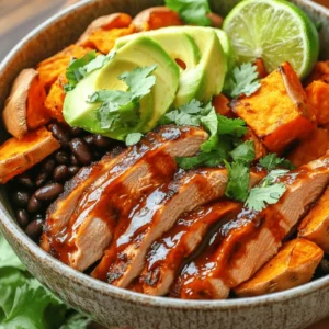 - 2 chicken breasts - 1 cup BBQ sauce (homemade or store-bought) - 2 medium sweet potatoes, diced - 2 tablespoons olive oil - 1 teaspoon smoked paprika - 1 teaspoon garlic powder - Salt and pepper to taste - 1 cup black beans, drained and rinsed - 1 avocado, sliced - 1 lime, cut into wedges - Fresh cilantro (for garnish) The main ingredients for your BBQ Chicken & Roasted Sweet Potato Bowls are simple but full of flavor. Chicken breasts are the star of the dish, providing protein and a savory base. You can use homemade or store-bought BBQ sauce, depending on what you have. Sweet potatoes add a natural sweetness and a nice texture. To spice things up, we season with smoked paprika and garlic powder. These add depth without being too strong. Black beans are a great topping. They boost protein and add heartiness to the meal. For fresh additions, slice up an avocado. It adds creaminess and balances the flavors. Lime wedges bring a zesty kick, making every bite pop. Finally, sprinkle fresh cilantro on top. It adds a burst of color and freshness. For the full recipe, check out the detailed instructions. Enjoy the process of creating this vibrant and satisfying meal! 1. Preheat your oven to 400°F (200°C). This heat helps the sweet potatoes cook well. 2. In a bowl, toss the diced sweet potatoes with olive oil, smoked paprika, garlic powder, salt, and pepper. Make sure they are well coated. 3. Spread the sweet potatoes on a baking sheet in a single layer. Roast them for 25-30 minutes. Flip them halfway through for even cooking. They should be tender and a bit caramelized when done. 1. While the sweet potatoes are roasting, season the chicken breasts with salt and pepper. This step enhances the flavor. 2. Heat a grill pan over medium heat. Grill the chicken for about 5-7 minutes on each side. Look for a nice golden color. 3. During the last couple of minutes, brush the chicken with BBQ sauce. This will glaze the chicken nicely. Make sure the chicken reaches an internal temperature of 165°F (75°C). Let it rest for a few minutes before slicing. 1. In each serving bowl, layer the roasted sweet potatoes, sliced BBQ chicken, and a scoop of black beans. This creates a colorful base. 2. Top with sliced avocado and squeeze lime juice over everything. This adds a fresh and zesty flavor. 3. For presentation, arrange the bowls beautifully. Use vibrant colors and add a lime wedge on the side. This makes the dish more appealing. Check out the Full Recipe for more details on this delicious meal! - To ensure chicken is juicy, use a meat thermometer. Cook until it hits 165°F (75°C). This keeps it moist. - For perfect roasting of sweet potatoes, cut them into even pieces. Use olive oil and season well. Roast at 400°F (200°C) for a golden finish. - Adjust BBQ sauce to taste. Start with a light coating, then add more if you like it saucy. - Pair your bowls with a fresh salad or coleslaw. This adds crunch and balances flavors. - These bowls are ideal for meal prep. Make a batch and store them for quick lunches. - Customize garnishes like lime wedges, extra cilantro, or hot sauce to fit your taste. - Must-have utensils include a sharp knife for chopping and a meat thermometer for chicken. - Recommended cookware is a grill pan for chicken and a baking sheet for sweet potatoes. - Useful gadgets for prep are a bowl for tossing sweet potatoes and a spoon for scooping beans. For more details, check out the Full Recipe. {{image_2}} You can change the proteins in this dish easily. If you want a meatless option, use tofu or tempeh instead of chicken. Both absorb flavors well. You can also try pork for a different taste. Feel free to swap out sweet potatoes, too. Carrots, parsnips, or beets work great as alternatives. Each root vegetable brings its own flavor and texture. You can also switch beans. Black beans are tasty, but chickpeas or kidney beans can add a new twist. They bring protein and fiber, making your meal more filling. Want to spice things up? Add jalapeños for heat. You can slice them thin or mix them into the BBQ sauce. This adds a kick to your dish! Experiment with sauces, too. Try different BBQ sauces like smoky or tangy. You can even use teriyaki or sriracha for a fun twist. Adding fresh herbs can brighten your meal. Cilantro is a great choice, but parsley or basil can also work. Just sprinkle them on top before serving. If you need a gluten-free meal, check the BBQ sauce label. Many brands are gluten-free, but it's good to double-check. You can also make your own sauce at home. For a vegan option, use tofu as your protein and skip the BBQ sauce with animal products. You can make a sweet and spicy sauce using maple syrup and apple cider vinegar. If you're watching carbs, you can reduce or skip the sweet potatoes. Instead, use zucchini or cauliflower rice. These options keep your bowl light but still satisfying. You can find the full recipe for BBQ Chicken & Roasted Sweet Potato Bowls in the main article. Store any leftover BBQ chicken and roasted sweet potato bowls in an airtight container. This keeps the food fresh and tasty. You can safely refrigerate these bowls for up to three days. If you plan to eat them later, make sure to cool them down before sealing the container. To freeze the components, first let everything cool to room temperature. Place the chicken and sweet potatoes in separate freezer bags. Squeeze out as much air as possible before sealing. These can last in the freezer for about three months. When you want to enjoy them, move them to the fridge to thaw overnight. For the best texture, reheat the chicken and sweet potatoes in the oven at 350°F (175°C) for about 15-20 minutes. Cover them with foil to keep moisture in. To avoid dryness in the chicken, add a splash of water or broth to the pan. This helps keep it juicy and tender. Enjoy your meal as if it was freshly made! Cook the BBQ chicken for about 10 to 14 minutes total. It's key to check the internal temperature. The chicken must reach 165°F (75°C) for safety. Cooking time can change based on thickness. Thicker pieces take longer, while thinner cuts cook faster. Always use a meat thermometer to ensure it’s done. Yes, you can use sweet potato fries instead of roasted sweet potatoes. Just bake or fry until crispy. This swap makes the dish easier. However, the flavor and texture will change. Fries are crispier, while roasted sweet potatoes are soft and sweet. Think about which texture you prefer. You can serve coleslaw or a green salad. Both add crunch and freshness. Cornbread is another great side that complements BBQ flavors. For drinks, try iced tea or lemonade. These drinks balance the rich BBQ taste. Enjoy your meal with a burst of refreshing flavors. This post covered how to make BBQ chicken and roasted sweet potato bowls. We looked at key ingredients like chicken, BBQ sauce, and sweet potatoes. I shared step-by-step cooking tips and variations for flavor. Storing tips help keep your meals fresh. I hope you feel ready to create your own tasty bowls. Experiment, enjoy, and share your delicious results with others!
