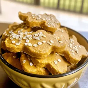 To make these easy pumpkin no-bake treats, gather these main ingredients: - 1 cup canned pure pumpkin (not pumpkin pie filling) - 1/2 cup rolled oats - 1/3 cup peanut butter (unsweetened and xylitol-free) - 1 cup whole wheat flour (or oat flour for gluten-free option) These ingredients are safe and healthy for dogs. Canned pure pumpkin offers fiber and vitamins. Rolled oats provide energy and are gentle on their tummies. Peanut butter adds a tasty flavor your dog will love. Whole wheat flour helps bind the dough together. If you want to boost the taste or nutrition, consider these optional ingredients: - 1/2 teaspoon cinnamon (optional) - 1/4 cup ground flaxseed (optional) Cinnamon can add a warm flavor that dogs enjoy. It also has anti-inflammatory properties. Ground flaxseed is a great source of omega-3 fatty acids. These good fats help keep your dog’s coat shiny and healthy. Every dog is different. Some may have dietary needs. Here are some substitute options: - Use oat flour instead of whole wheat flour for gluten-free treats. - If your dog has nut allergies, try sunflower seed butter instead of peanut butter. These substitutes ensure all dogs can enjoy these yummy treats. Always check with your vet if you're unsure about an ingredient. For the full recipe, check out the details above. To make these easy pumpkin no-bake treats, start with a large mixing bowl. Add 1 cup of canned pure pumpkin, 1/2 cup of rolled oats, and 1/3 cup of peanut butter. Mix these ingredients well until they blend together. You want a smooth, thick mixture. This step is key. It gives your treats their base flavor and texture. If you want to boost the flavor, consider adding 1/2 teaspoon of cinnamon and 1/4 cup of ground flaxseed. These ingredients are optional but offer great benefits. Cinnamon can help with digestion, and flaxseed adds healthy fats. Mix these in until evenly distributed. This extra step can make your treats even more delicious for your furry friend. Once your mixture is ready, gradually add 1 cup of whole wheat flour. Add it a little at a time while stirring. The dough should be firm but not sticky. Knead the dough gently on a floured surface until it holds together. Roll it out to about 1/4 inch thick. Now, you can use cookie cutters to cut out shapes. If you prefer, simply roll the dough into small balls. Place the shaped treats on a parchment-lined baking sheet. Let them rest for at least 30 minutes to firm up. After they set, store them in an airtight container. These easy pumpkin no-bake treats are ready to delight your dog! To get the right dough, you want it firm but not sticky. Start by mixing the pumpkin, oats, and peanut butter well. When adding flour, do it a bit at a time. This helps you control the dough's thickness. If your dough feels too wet, add more flour. If it’s too dry, a touch of water or pumpkin can help. The perfect dough is easy to handle and holds its shape. Shaping these treats can be fun! Use cookie cutters to make fun shapes like bones or hearts. If you want it simple, roll the dough into balls. Each ball can be a tasty surprise for your dog. You can also flatten the balls slightly for a more traditional cookie look. Get creative! The shapes can add excitement for your pup when it’s treat time. Serving these treats can be just as fun as making them. Place the treats in a cute dog bowl. You can add a sprinkle of oats on top for a nice touch. If you want to go the extra mile, try a dog-friendly frosting. A little decoration makes the treats look special. Dogs love good food, and how it looks can make it even better! {{image_2}} Dogs can be picky eaters. You might want to switch up the flavors to keep things fun. Try adding pureed sweet potato or mashed banana. Both are tasty and healthy. You can even mix in some shredded carrots for a crunchy twist. These variations add different tastes and nutrients. Your dog will love exploring new flavors! Some dogs need special diets. For a gluten-free treat, swap whole wheat flour for oat flour. Oat flour is safe and easy for most dogs to digest. If your dog is grain-free, you can stick to oats. Just make sure the oats are certified gluten-free. This way, your pup can enjoy treats without any worries. You know your dog's needs best. If your dog is overweight, use less peanut butter. You can also add more pumpkin for extra fiber. For dogs with allergies, check labels carefully. You can replace peanut butter with sun butter or pumpkin seed butter. These swaps help you create a treat that suits your dog's unique needs. For the full recipe, check the section above and start making these tasty snacks for your furry friend! To keep your easy pumpkin no-bake treats fresh, store them in an airtight container. This method locks in moisture and flavor. Place the container in the refrigerator to maintain freshness. Avoid leaving them out at room temperature, as this can lead to spoilage. When stored correctly, these treats last about one week in the fridge. After that, they may start to lose flavor and texture. Always check for any signs of spoilage before giving them to your dog. If they smell off or look different, it’s best to discard them. If you want to keep the treats longer, consider freezing them. Place the treats in a freezer-safe bag or container. They can last for up to three months in the freezer. When ready to serve, simply take out a few treats. Let them thaw at room temperature for a few minutes before giving them to your dog. This method keeps the treats tasty and fresh for a long time! For the full recipe, check out the instructions above. Yes, dogs can eat pumpkin. It is safe and healthy for them. Pumpkin is full of fiber. This helps with digestion and keeps your dog’s tummy happy. It also has vitamins A and C. These vitamins boost their immune system. The antioxidants in pumpkin can help fight disease. Many dogs enjoy the taste of pumpkin, making it a great treat. To check for allergies, start with a small amount. Give your dog one treat and watch for signs. Look for itching, swelling, or upset stomach. If you see any of these signs, stop giving that treat right away. You can also consult your vet for help. They can suggest tests to identify food allergies. If your dog doesn’t like the treats, don’t worry! Many dogs have different tastes. Try changing the recipe a bit. You can add different flavors or use other ingredients. For example, try adding mashed banana or sweet potato. You can also roll the treats in a bit of peanut butter. If your dog still doesn't like them, try a different recipe. There are many tasty options available for dogs. You learned how to make easy pumpkin no-bake treats for your dog. We covered main and optional ingredients, plus substitutions for special diets. You now know how to prepare, shape, and store these tasty treats. I shared tips to ensure the right texture and ways to get creative with shapes. Remember, your dog's health matters. Always check for allergies and adapt recipes as needed. Enjoy making treats that will delight your furry friend!