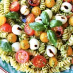To make a delightful Minute Caprese Pesto Pasta Salad, you will need the following fresh ingredients: - 8 oz rotini pasta - 1 cup cherry tomatoes, halved - 1 cup fresh mozzarella balls (bocconcini), halved - 1/2 cup fresh basil leaves, plus extra for garnish - 1/4 cup pesto sauce - 2 tablespoons extra virgin olive oil - Salt and pepper to taste - Balsamic glaze for drizzling (optional) These ingredients blend together to create a vibrant dish. The rotini pasta provides a fun twist, while the cherry tomatoes add sweetness. Fresh mozzarella brings creaminess, and basil offers a fragrant touch. Pesto sauce ties everything together with bold flavor, making this salad both fresh and satisfying. If you want to add a sweet finish, drizzle balsamic glaze over the top. This salad is perfect for picnics, potlucks, or a quick weeknight meal. Start by boiling water in a large pot. Add 8 oz of rotini pasta. Cook it according to the package instructions. This usually takes around 8 to 10 minutes. Stir it occasionally to prevent sticking. When done, drain the pasta in a colander. Rinse it under cold water to stop the cooking. This keeps the pasta firm and perfect for the salad. In a big mixing bowl, combine the cooled rotini pasta with 1 cup of halved cherry tomatoes and 1 cup of halved fresh mozzarella balls. This mix gives great color and taste. Next, let’s make the basil-pesto dressing. In a food processor, add 1/2 cup of fresh basil leaves, 1/4 cup of pesto sauce, and 2 tablespoons of extra virgin olive oil. Blend until smooth. This dressing adds a fresh flavor to your salad. Now, pour the basil-pesto dressing over the pasta mixture. Gently toss everything together until all the pasta and veggies are coated. Season with salt and pepper to taste, mixing well. You can serve the salad right away or chill it in the fridge for about 30 minutes. This helps the flavors blend. When ready to serve, garnish with extra basil leaves. If you like, drizzle some balsamic glaze on top for added flavor. Enjoy your fresh, tasty dish! To cook pasta well, follow these steps: - Use a large pot for boiling water. This helps the pasta cook evenly. - Add a pinch of salt to the water before boiling. It enhances flavor. - Stir the pasta often while cooking. This keeps it from sticking together. - Check the package for cooking time. Aim for al dente, which means firm to the bite. - Once cooked, drain the pasta but do not rinse it if you want the sauce to stick well. To cool the pasta properly, rinse it under cold water right after draining. This stops the cooking and keeps the texture just right. Spread it out on a baking sheet to cool faster if you have time. To make your pesto even better, try these tips: - Mix in some garlic or lemon juice for a fresh kick. - Swap basil for other herbs like parsley or arugula. This gives new flavors. - Add some nuts, like walnuts or pine nuts, for extra crunch. - For a spicy twist, include red pepper flakes. Just a pinch can change the dish. Feel free to experiment! Each change can lead to a unique taste that suits your style. Pair your pasta salad with proteins for a complete meal: - Grilled chicken adds great flavor and makes it more filling. - Shrimp gives a nice touch and pairs well with the pesto. When serving, use a large bowl or platter. This allows everyone to see the colorful ingredients. Tongs work best for serving. They help you scoop out the salad easily without making a mess. Enjoy the beautiful presentation and the delicious taste! {{image_2}} You can easily add protein to your Minute Caprese Pesto Pasta Salad. - Grilled chicken: This option gives a nice, smoky flavor. Simply grill chicken breasts and slice them up. Toss the pieces into your salad for a filling meal. - Shrimp options: Cooked shrimp can add a sweet taste. You can grill or sauté them. Add them just before serving to keep them tender. If you want a vegan version, it’s simple to make a few swaps. - Substituting cheese and pesto: Use vegan mozzarella or skip the cheese altogether. For pesto, try a nut-based version without cheese. Blend nuts, herbs, and olive oil for a tasty sauce. - Added veggies for extra nutrition: Consider adding spinach, bell peppers, or zucchini. These veggies boost the nutrients and add color. Using fresh, seasonal ingredients can make this dish even better. - Incorporating fresh vegetables: Try adding sliced cucumbers, radishes, or arugula. They bring crunch and freshness to the salad. - Utilizing different types of pasta: You can swap rotini for penne or farfalle. Each type of pasta offers a unique texture and can change the dish's look. These variations keep your pasta salad exciting and suitable for everyone! Store your Minute Caprese Pesto Pasta Salad in the fridge. Use an airtight container to keep it fresh. This helps avoid any unwanted odors or flavors from other foods. Glass or plastic containers work well for storage. Make sure the lid seals tightly to lock in the taste. You can freeze this pasta salad for longer storage. For freezing, place it in a freezer-safe bag or container. Remove as much air as possible to prevent freezer burn. When it's time to eat, thaw it in the fridge overnight. Reheat it gently on the stove. Stir it slowly to keep the texture nice. If it seems dry, add a splash of olive oil for moisture. In the fridge, your pasta salad lasts about three to four days. Keep an eye out for signs that it’s time to toss it. If you see mold or if it smells off, discard it right away. Freshness matters, so enjoy it while it’s still tasty! It takes just 10 minutes to prep and 20 minutes total. You can cook the rotini pasta quickly. While it cooks, you can chop the tomatoes and cheese. Mix everything together, and you’re done! Yes, you can make this salad ahead. If you want the best taste, chill it for about 30 minutes before serving. This wait allows the flavors to blend well. You can also store it in the fridge for a few hours. If you don’t have pesto, you can use store-bought or homemade options. Try using sun-dried tomato paste or a mix of garlic and olive oil. Fresh herbs like parsley or arugula also work great. They add a special twist to the salad. Absolutely! You can swap the rotini for any pasta shape you like. Penne, farfalle, or even whole wheat pasta are great choices. Just make sure to cook it according to the package instructions. This blog post guided you through making a delicious Caprese Pesto Pasta Salad. We covered the key ingredients, like rotini pasta, cherry tomatoes, and fresh basil. Then, I shared steps for cooking pasta, mixing the salad, and assembling it all together. You learned helpful tips, such as customizing the pesto and pairing it with protein. Finally, I outlined storage methods for keeping your salad fresh. Enjoy experimenting and making this salad your own!