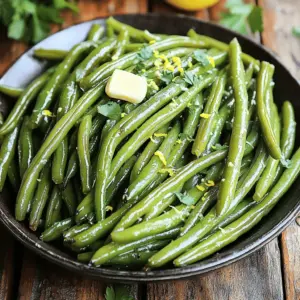 You need 1 pound of fresh green beans. Make sure they are bright green and firm. Trim the ends to prepare them for cooking. Rinse the beans under cold water and dry them with a paper towel. For the garlic butter mix, gather these ingredients: - 3 tablespoons unsalted butter, melted - 4 cloves garlic, minced - 1 teaspoon lemon zest - 1 teaspoon garlic powder - ½ teaspoon salt - ¼ teaspoon black pepper Melt the butter in the microwave or on the stove. Then, mix all the other ingredients into the melted butter. Finally, you’ll want fresh parsley for garnish. Chop up about 1 tablespoon of parsley. This adds a pop of color and fresh taste to your dish. These simple ingredients create a flavorful and tasty side dish that everyone will love. First, set your air fryer to 350°F (175°C). Let it preheat for about 5 minutes. This step is key for even cooking. Next, rinse 1 pound of fresh green beans under cold water. Trim the ends to remove any tough parts. Then, pat them dry with a paper towel. Dry beans help the garlic butter stick better. In a small bowl, mix together 3 tablespoons of melted unsalted butter, 4 minced garlic cloves, 1 teaspoon of lemon zest, 1 teaspoon of garlic powder, ½ teaspoon of salt, and ¼ teaspoon of black pepper. Stir until all ingredients blend well. This mixture adds great flavor. Take a large mixing bowl and add your prepared green beans. Pour the garlic butter mixture over the beans. Toss them well to coat each bean with the mixture. This helps every bite taste amazing. Place the coated green beans in the air fryer basket. Make sure they lay in a single layer. If your air fryer is small, you may need to cook in batches. Air fry the beans for 8-10 minutes. Shake the basket halfway through to cook them evenly. They should be tender and slightly crispy. When the green beans are done, take them out of the air fryer. Put them in a serving dish. For a pop of color and taste, sprinkle 1 tablespoon of chopped fresh parsley on top before serving. Enjoy! To make crispy green beans, follow these steps: - Dry the Beans: Make sure to pat the green beans dry after rinsing. - Single Layer: Place the beans in a single layer in the air fryer. - Shake the Basket: Shake the basket halfway through cooking to help them crisp up. - Adjust Time: If you want them crispier, add a few more minutes. Each air fryer can cook differently. Keep these tips in mind: - Check Your Manual: Some air fryers may need less time. - Start at 8 Minutes: Begin with 8 minutes and check for doneness. - Use a Food Thermometer: The beans should be tender and have a slight crunch. To ensure your green beans have great flavor, try these techniques: - Coat Evenly: Toss the green beans well in the garlic butter mix. - Mix Seasonings: Consider mixing your seasonings before adding them to the beans. - Garnish Last: Add fresh parsley after cooking to keep it vibrant and fresh. {{image_2}} You can make garlic butter air fryer green beans a full meal by adding protein. Try adding cooked chicken, shrimp, or tofu. Just toss your choice of protein with the green beans in the garlic butter mixture. Cook everything together in the air fryer for a tasty dish. Feel free to switch up the flavors. Instead of garlic powder, try onion powder or smoked paprika. You can also add red pepper flakes for some heat. Lemon pepper seasoning adds a bright twist. Experiment to find what you love best! Want to add more veggies? Green beans pair well with bell peppers, zucchini, or asparagus. Cut them into similar sizes for even cooking. Toss them in the garlic butter mix just like the green beans. This adds color and flavor to your dish. To store your garlic butter air fryer green beans, first let them cool. Then, place the beans in an airtight container. They can stay fresh in the fridge for up to three days. Make sure to seal the container well to keep out air and moisture. When you’re ready to eat your leftovers, reheat them in the air fryer. Set it to 350°F (175°C) for about 5 minutes. This method brings back their crispness. You can also use a microwave, but they may not stay as crunchy. If you want to freeze the green beans, first let them cool completely. Next, place them in a freezer-safe bag. Try to remove as much air as possible before sealing. They can last in the freezer for up to three months. To use them later, thaw them in the fridge overnight before reheating. Yes, you can use frozen green beans. They are a great time-saver. Just remember to thaw and drain them first. This helps avoid excess water. Frozen beans may need a little extra cooking time. Check them after 10 minutes to see if they are tender. You can mix in many flavors. Try adding red pepper flakes for some heat. Lemon juice gives a fresh taste. For a nutty flavor, add toasted almonds. You can also use herbs like thyme or rosemary. Feel free to experiment with spices you love. Check the green beans after 8 minutes. They should be bright green and tender. If you want a crispier bite, cook them for another 2 minutes. Shake the basket halfway through cooking for even results. This helps them cook perfectly all around. Absolutely! Cheese adds a creamy touch. Parmesan is a great choice. Just sprinkle it on right after cooking. The heat will melt it slightly. You can also try feta for a tangy flavor. Cheese makes this dish even more delicious. This article covers all you need for tasty garlic butter green beans. We discussed fresh green beans, homemade garlic butter, and the right seasonings. You learned how to air fry the beans and achieve the perfect crunch. I shared tips for different air fryers and cooking techniques. We also explored fun variations, like adding proteins and different veggies. Finally, I provided simple storage and reheating methods. With these steps, your garlic butter green beans will shine at any meal!