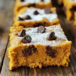 To make delicious pumpkin bars with cake mix, you need a few key ingredients. Here’s what you will need: - 1 box of spice cake mix - 1 cup canned pumpkin puree - 1/2 cup vegetable oil - 3 large eggs - 1 teaspoon vanilla extract - 1 teaspoon pumpkin pie spice - 1/2 teaspoon cinnamon - 1 cup chocolate chips (optional) - Powdered sugar for dusting (optional) Each of these ingredients plays a crucial role. The spice cake mix provides a rich base. The canned pumpkin puree adds moisture and flavor. Vegetable oil keeps the bars soft. Eggs help bind everything together. Vanilla extract brings a sweet aroma. Pumpkin pie spice and cinnamon give that warm, cozy taste we all love. You can add chocolate chips for extra sweetness, but it is optional. Lastly, dusting with powdered sugar gives a nice touch. Gather all your ingredients before you start. This way, you’ll have everything ready to go! Start by preheating your oven to 350°F (175°C). This step is key for even baking. Next, take a 9x13 inch baking pan and grease it. You can use cooking spray or a little oil. This keeps the bars from sticking. In a large mixing bowl, combine the spice cake mix, canned pumpkin puree, and vegetable oil. Crack in three large eggs and add a teaspoon of vanilla extract. Mix these well until smooth. The batter will be thick and creamy. Next, add a teaspoon of pumpkin pie spice and a half teaspoon of cinnamon. Stir until everything blends together. If you want extra sweetness, fold in one cup of chocolate chips. Pour the batter into your greased pan and spread it evenly. Bake for 25-30 minutes. Check if they are done by inserting a toothpick in the center. If it comes out clean, they are ready. After baking, take the pan out of the oven. Let it cool for about 10 minutes. Then, move the bars to a wire rack to cool completely. Once cool, cut them into bars. If you like, dust them with powdered sugar for a pretty finish. Enjoy your delicious pumpkin bars! For the best texture in your pumpkin bars, use a thick canned pumpkin puree. This helps keep the bars moist but not too wet. I suggest mixing the batter well, but not overmixing. Overmixing can make your bars tough. Bake until a toothpick comes out clean, usually 25 to 30 minutes. Let them cool in the pan for at least 10 minutes before moving them. This step helps them hold their shape. To boost the flavor, add more spices if you like. Try adding extra cinnamon or nutmeg. You can also mix in some chopped nuts for a nice crunch. If you want a sweet touch, fold in chocolate chips. They melt slightly and add a rich flavor to the bars. Using high-quality vanilla extract can also enhance the taste. When serving your pumpkin bars, cut them into neat squares for a clean look. You can dust them with powdered sugar for a pretty finish. Serve on a colorful plate to make them pop. For a fun twist, top each bar with a dollop of whipped cream or a scoop of vanilla ice cream. This adds a nice contrast to the spice and pumpkin flavors. {{image_2}} If you want to make these pumpkin bars gluten-free, you can swap the spice cake mix. Look for a gluten-free cake mix at your store. It should work just as well. You may also use almond flour or coconut flour. Both give great flavor and texture. Be sure to check the labels for any hidden gluten. You can change some ingredients based on what you have. For example, you can use olive oil instead of vegetable oil. This adds a nice flavor. If you don’t have pumpkin pie spice, mix equal parts cinnamon, nutmeg, and ginger. If you want to skip the eggs, try using applesauce. Use 1/4 cup of applesauce for each egg. This keeps the bars moist and tasty. To make your pumpkin bars extra special, add seasonal flavors. You might mix in some chopped nuts, like pecans or walnuts. You can also add dried cranberries for a sweet and tart touch. Experiment with a splash of maple syrup for a rich flavor. Don't forget to sprinkle some extra cinnamon on top for a cozy finish. These little twists can make each bite even more delightful! To keep your pumpkin bars fresh, store them in an airtight container. Place a layer of parchment paper between the bars to prevent sticking. You can also cover the container with plastic wrap. This helps keep the bars moist and tasty. You can freeze pumpkin bars for later. First, let them cool completely. Cut them into individual bars. Wrap each bar in plastic wrap, then place them in a freezer bag. Remove as much air as possible. They will stay fresh in the freezer for up to three months. When stored in the fridge, these pumpkin bars last about five days. If you freeze them, they can last up to three months. Just remember, the sooner you eat them, the better they taste! Yes, you can make these pumpkin bars vegan. Simply swap the eggs for a plant-based option. Use 1/4 cup of unsweetened applesauce for each egg. You can also use flaxseed meal. Mix 1 tablespoon of flaxseed meal with 2.5 tablespoons of water. Let it sit for a few minutes until it thickens. This will help bind your bars just like eggs. You have several great options to replace eggs in this recipe. Here are a few: - 1/4 cup of unsweetened applesauce - 1 tablespoon of flaxseed meal mixed with 2.5 tablespoons of water - 1/4 cup of silken tofu, blended - 1/4 cup of mashed banana Each of these options works well and keeps the bars moist. You can check if the pumpkin bars are done by using a toothpick. Insert it into the center of the bars. If it comes out clean or with a few crumbs, they are done. If you see wet batter, they need more time. Bake them for 25-30 minutes, and keep an eye on them towards the end. Let them cool for a bit before cutting. You learned how to make tasty pumpkin bars using simple ingredients and steps. We covered soft textures, flavor tips, and fun ways to serve. Don’t forget about storage to keep them fresh. Try different variations to suit your taste or dietary needs. These pumpkin bars are sure to impress. Now, gather your ingredients, follow the steps, and enjoy your delicious treat!